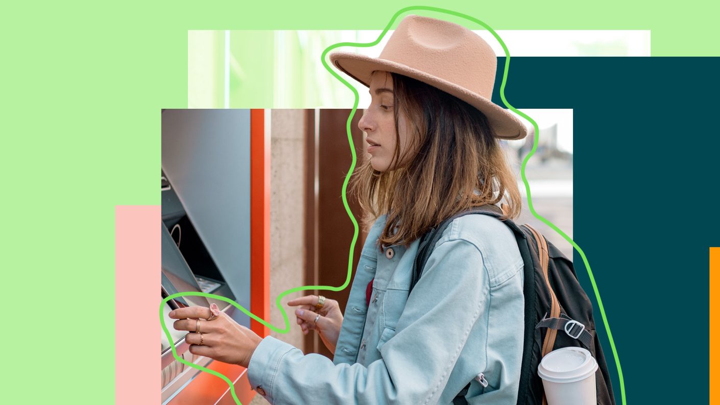 Young woman with hat redrawing cash