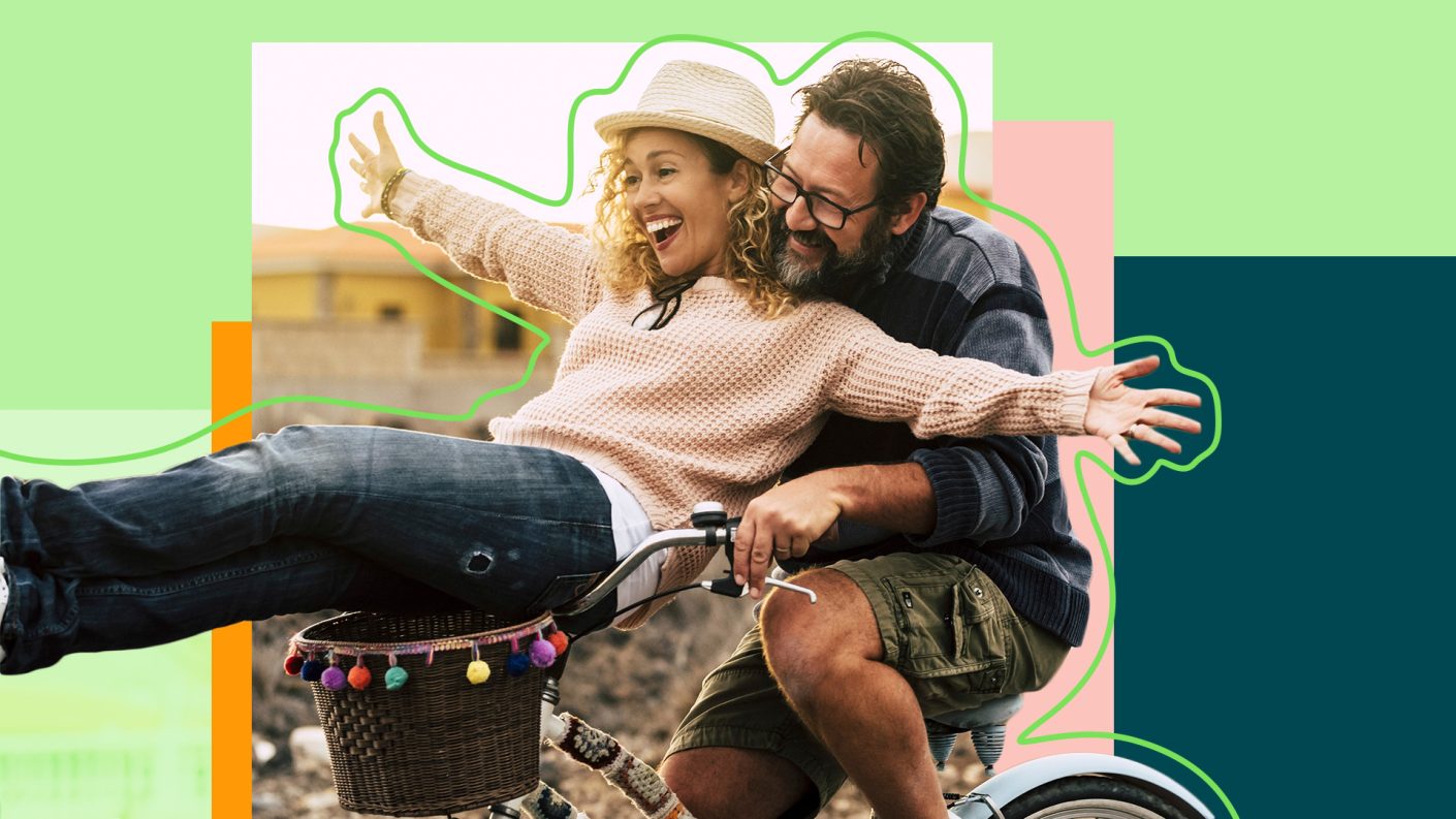 Two happy people on a bike