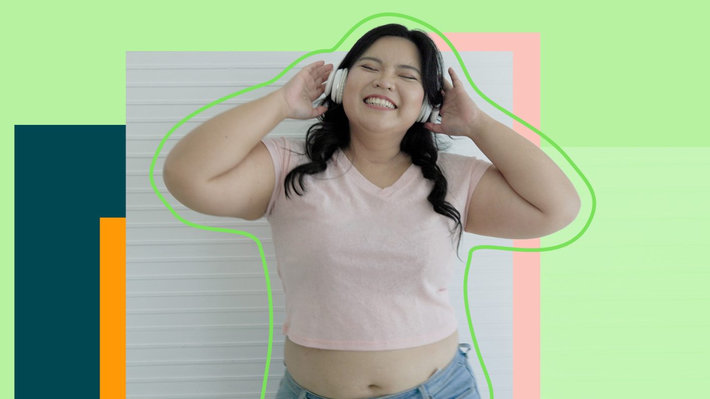 Happy young woman listening to music