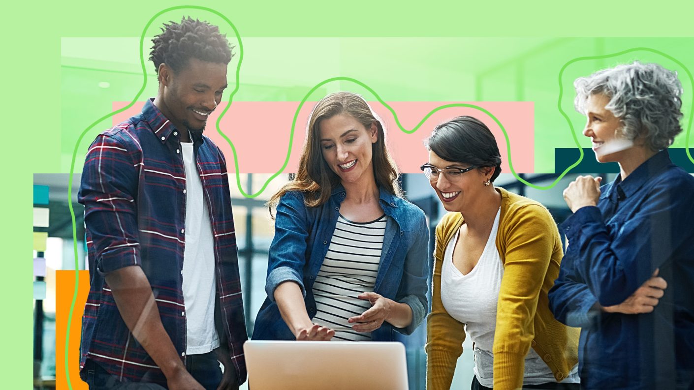 Diverse group of people talking around a laptop