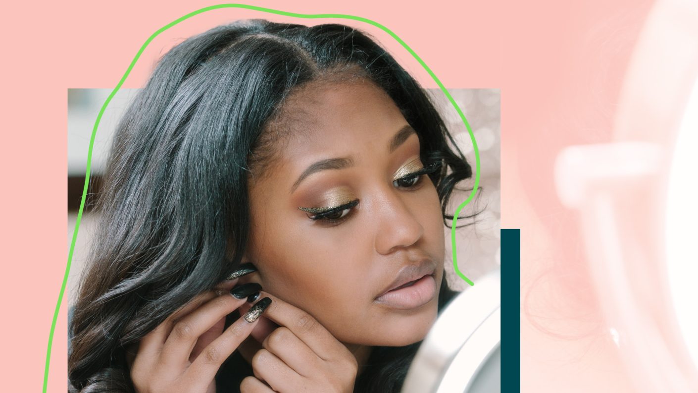 A person putting on earrings