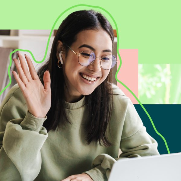 A person smiling and waving on a laptop call