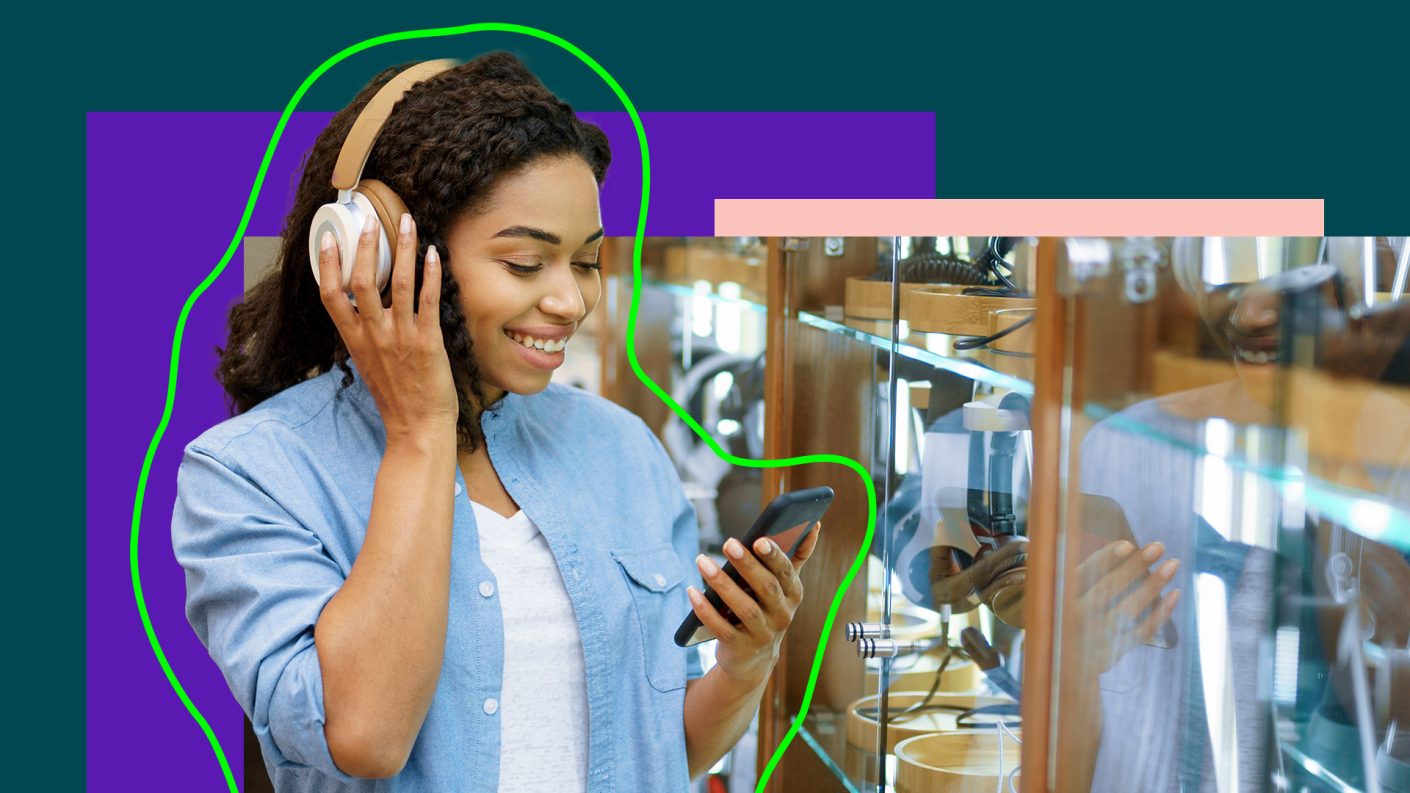 Person wearing headphones and watching their phone