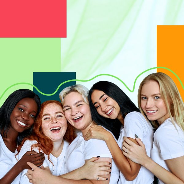 Smiling women holding each other and laughing