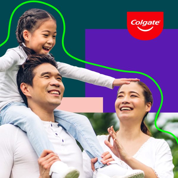 Father, mother and child smiling. Child sits on dad's shoulder pretending to be a plane.