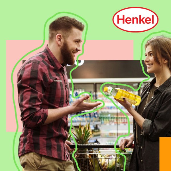 Two people discussin in supermarket, one holding a bottle