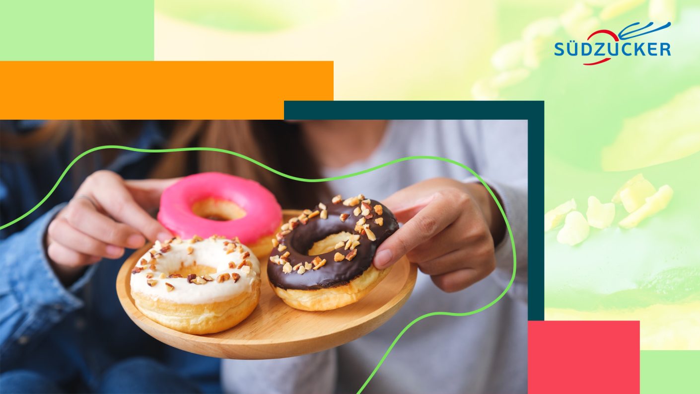Hands taking doughnuts from a tray